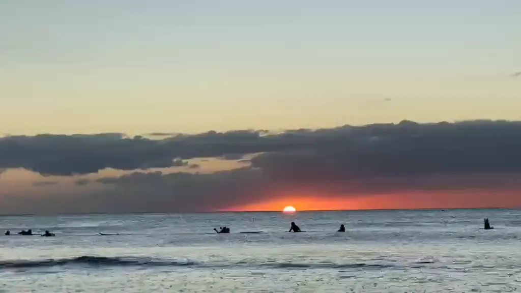 Sunrise over Tamarin Bay, the lineup waiting in silhouette.