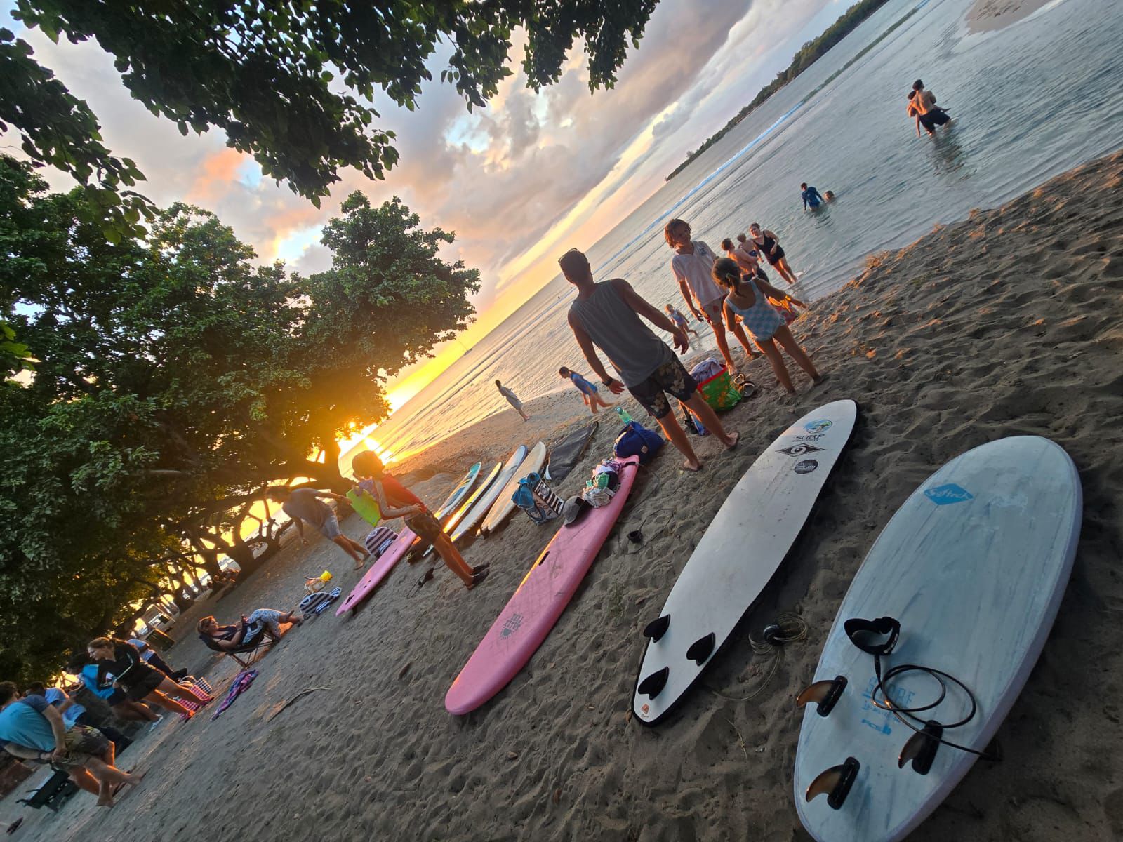 Kids gathering on the beach for Sunset Duckies training at sunset.