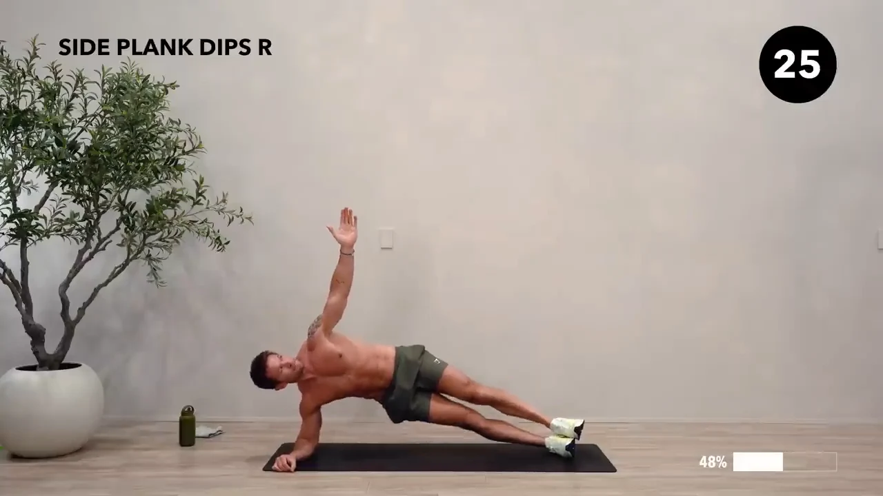 Dan the HIIT Man demonstrating side plank dips — right.