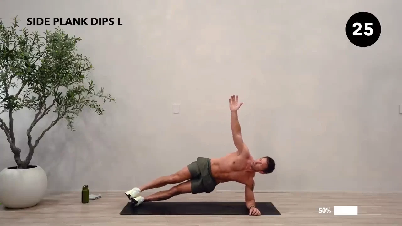 Dan the HIIT Man demonstrating side plank dips — left.
