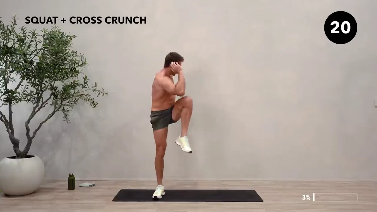 Dan the HIIT Man demonstrating squat + cross crunch.