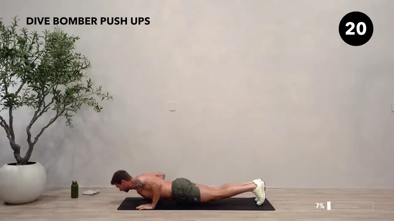 Dan the HIIT Man demonstrating dive bomber push-ups.